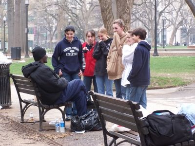 Teens talk with homeless man